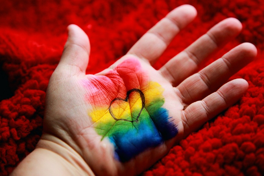 A heart and a rainbow designed on a hand