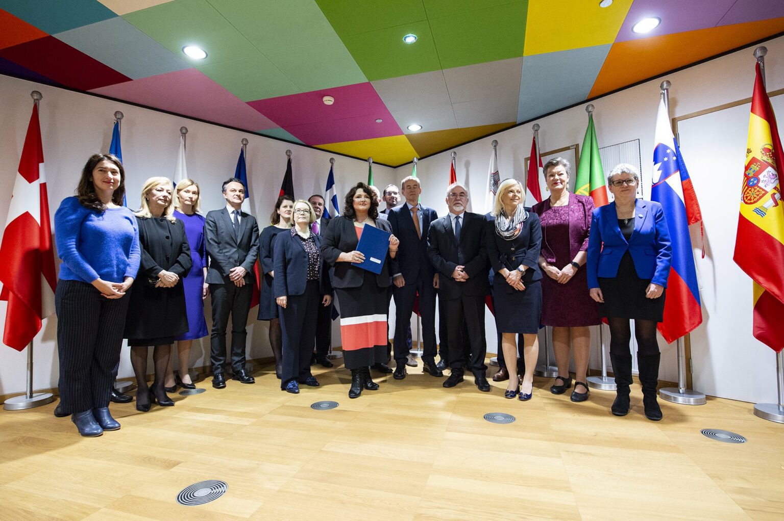 a group of MEPs pose with their national flags