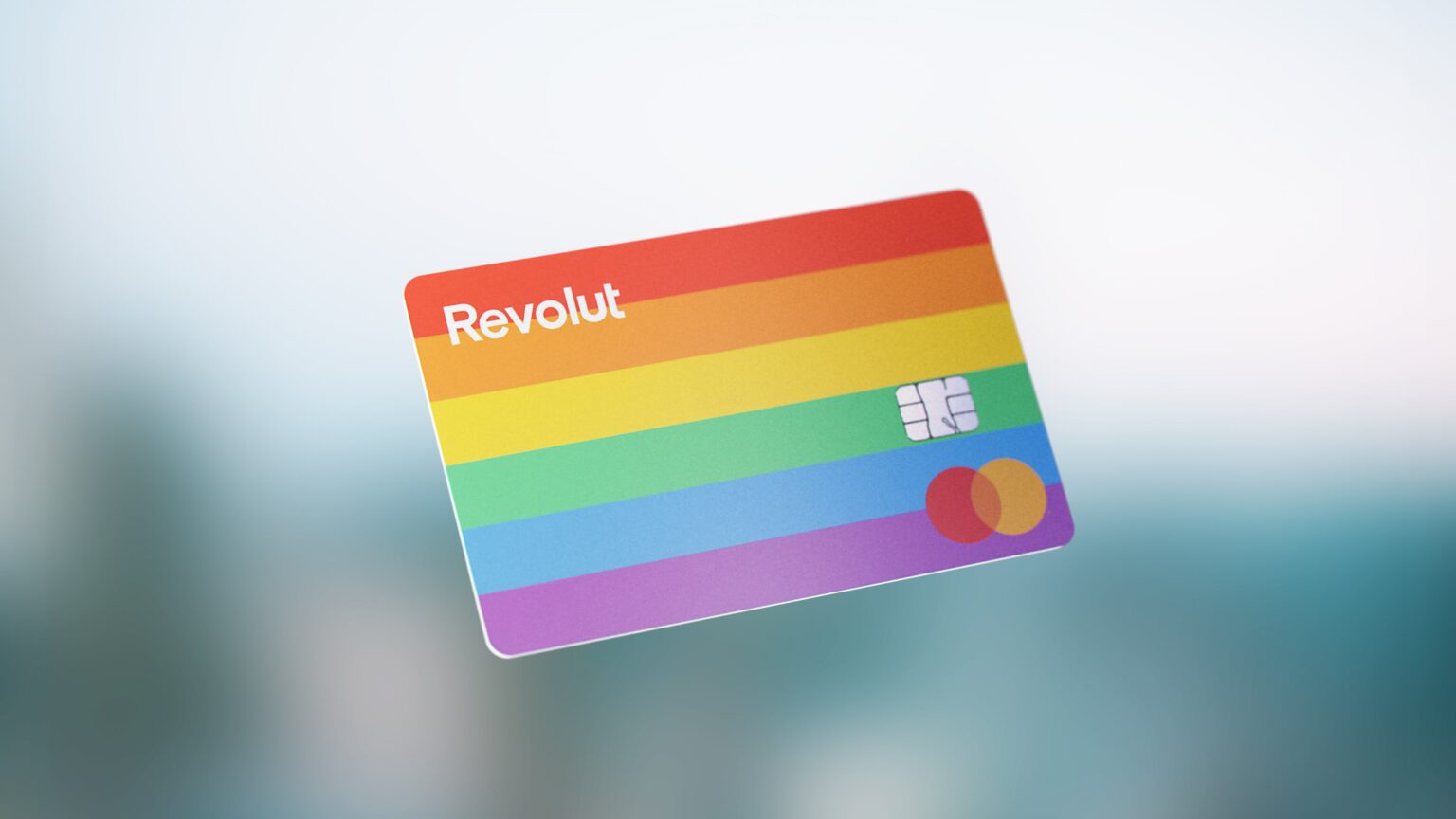 credit card with rainbow colours floats against a blurred background