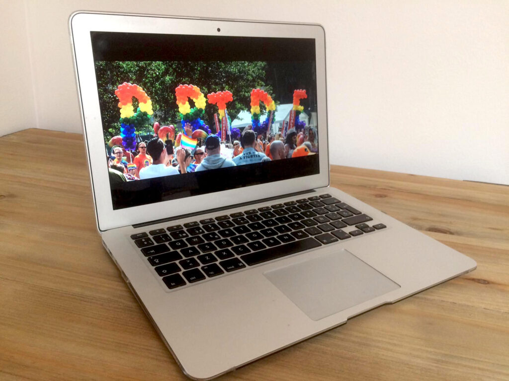 A laptop screen showing an image of Pride