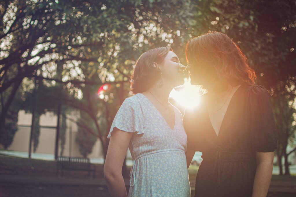 Two women kissing in the sunset