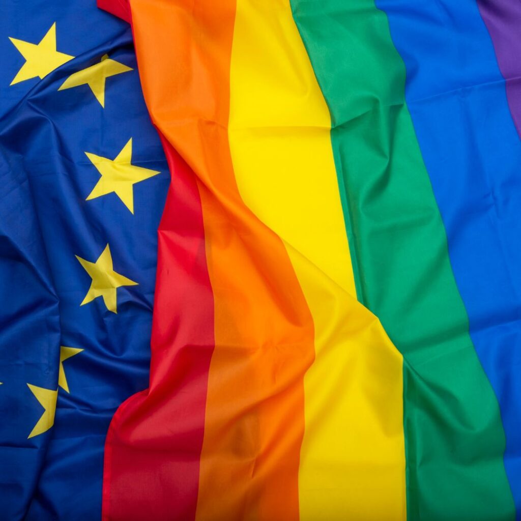 An EU flag and an LGBTI rainbow flag are juxtaposed