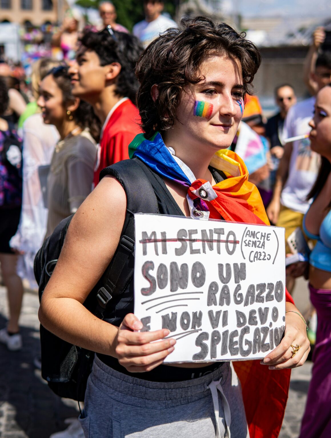 A woman protests Italian anti-LGBTI legislation with rainbow flag