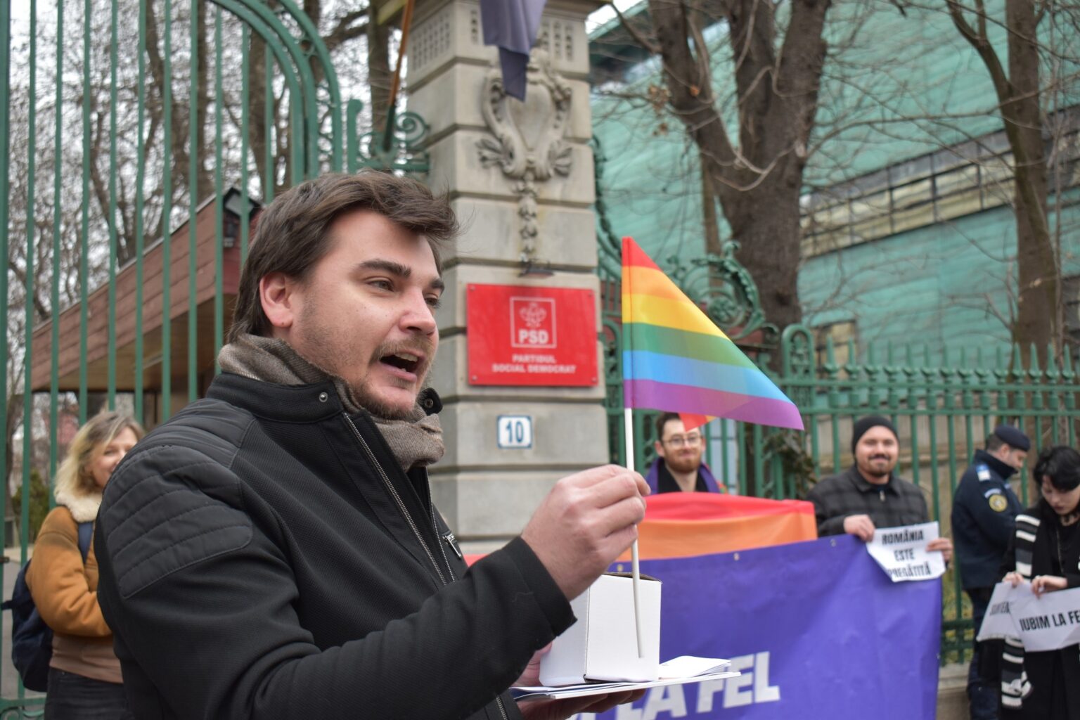 A photo of Vlad holding a rainbow flag